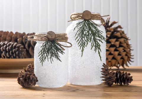 Lighted-mason-jar-Christmas-luminaries-in-front-of-pinecones
